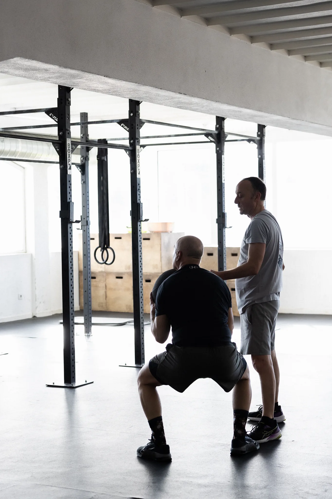 Coach a acompanhar um agachamento no rig da box
